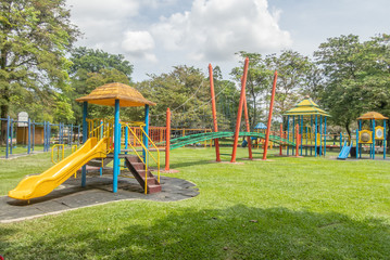 Colorful kid's playground on yard in the park with selective focus