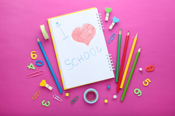 Inscription I Love School with school supplies on pink background
