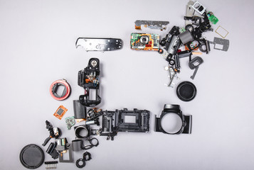 Fototapeta premium Different parts with a photo camera on a gray background.