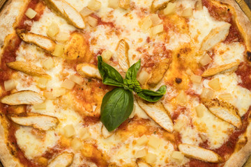 Pizza with chicken breast, pineapple and mozzarella cheese