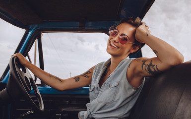 Woman with sunglasses driving a car.