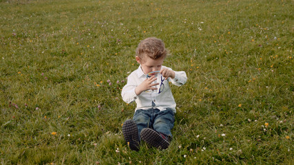 child in glasses on the grass