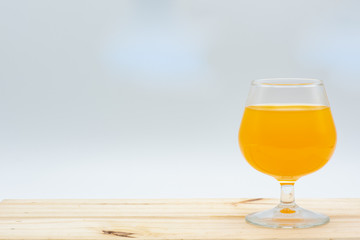 One glass of orange juice on a table