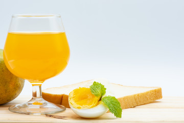 Orange juice in glass with heathy foods on wood table