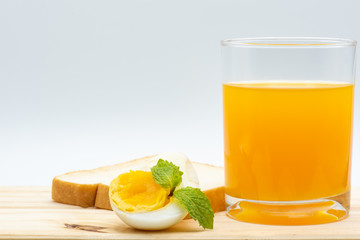 Orange juice in glass with heathy foods on wood table