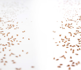Fototapeta na wymiar Flax seeds scattered over white background