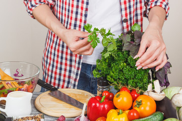 Woman cooks at the kitchen