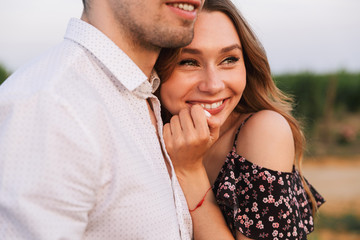 Happy cute loving couple outdoors hugging with each other.