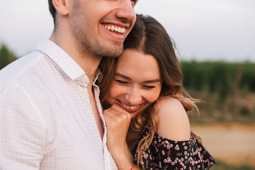 Obraz premium Happy cute loving couple outdoors hugging with each other.