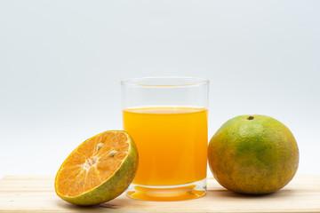 Orange juice in glass with sliced orange on wood table