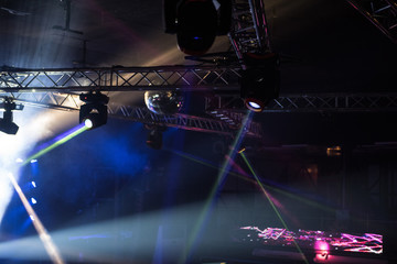 Defocused entertainment concert lighting on stage, blurred disco party.