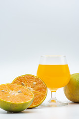 Close up glass of orange juice with sliced orange