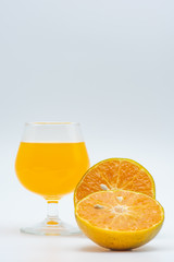 Close up glass of orange juice with sliced orange