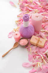 Pile of many pink petals background with and herbal,candle ,soap ,salt in bowl,