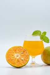 Close up glass of orange juice with sliced orange