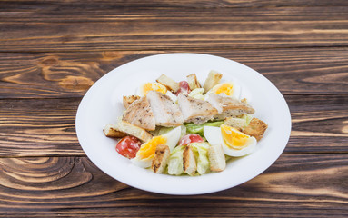 Caesar salad with chicken, in a plate