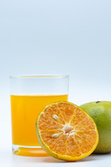 Close up glass of orange juice with sliced orange