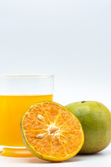 Close up glass of orange juice with sliced orange