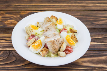 Caesar salad with chicken, in a plate