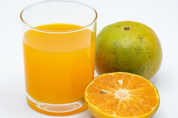 Close up glass of orange juice with sliced orange