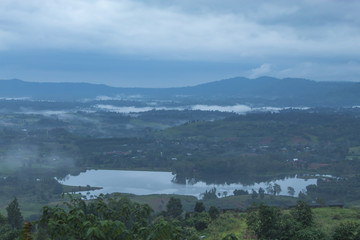 Morning mist above the reservoir and the trees at Phetchabun in Thailand.