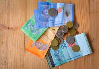 Malaysian currency, Bank notes and coins on wooden table.