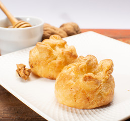 French snack pouches made from puff pastry with fresh soft goat cheese and honing