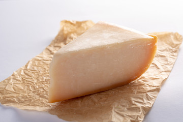 Dutch old Amsterdam  cheese, made from  goat milk on white background