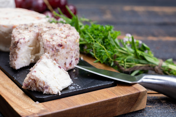 French soft cheeses, variety of different taste goat milk natural cheeses on granite plate close up sesrved as dessert