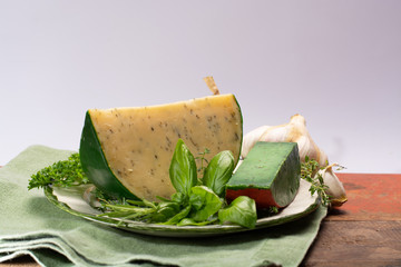 Dutch specialty hard cheese made from cows milk with different spices and fresh green herbs
