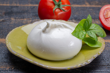 Fresh soft white burrata, ball buttery cheese, made from a mix of mozzarella and ricotta cream, original from Apulia region, Italy, very popular soft cheese in USA
