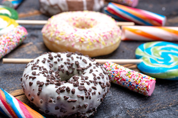 Children party background with sweet colorful donuts and candy