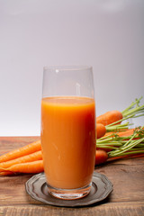 Tasty healthy natural sweet vegetable drink, fresh organic carrot juice ready to drink in glass
