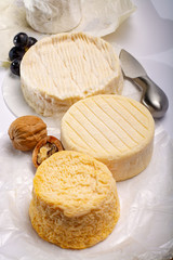 French AOC soft cow cheeses, crumbly Langres with washed rind structure, sharp Pie Angloys, camembert with strong taste and brie served as dessert after dinner