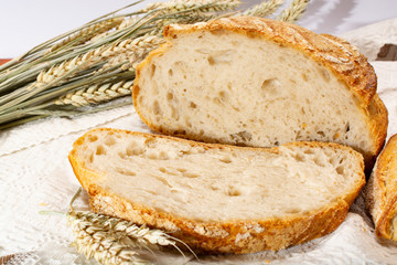 Sourdough homemade round white wheat bread with slices close up