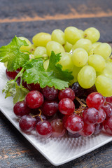 Sweet ripe grapes berries in bowl ready to eat close up