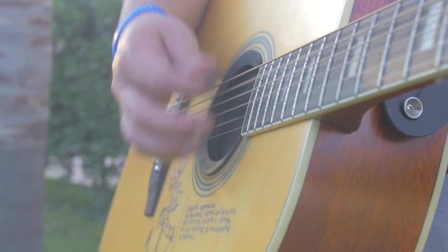 Guy play guitar outdoor