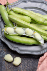 New harvest of healthy vegetables, green fresh raw big broad beans close up