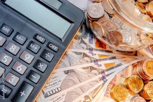 Calculator With Currency Gl Jar And Gold Coins Stack Dollar Calculator With Currency Gl Jar And Gold Coins Stack Dollar Euro Banknotes On The Table Compound Interest Rate Calculation Or Financial Investment