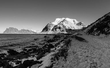 Scenic view of beautiful winter sea scandinavian landscape with mountains and snow at Lofoten Islands in Northern Norway. Black and white.