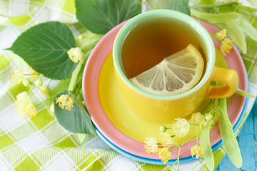 Cup of herbal tea with linden blossoms and lemon