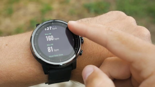 Results of a running training session on smart watch. Smartwatch. Hand with sports watch which shows results of training. Pulse, speed, distance, calories