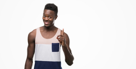 Young african american man surprised with an idea or question pointing finger with happy face,...