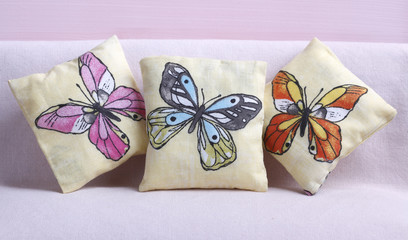 Pillows with butterflies on pink background