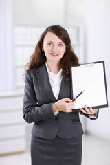 modern business woman pointing at blank sheet.