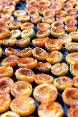 Homemade dried apricots. A leaf with halves of apricots
