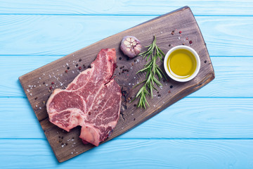 Raw beef steak T bone with ingredient