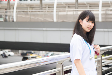 A Young Asian doctor  White Shirt suit with stethoscope outdoor Hospital.