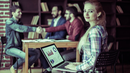 accountant works with financial charts on the laptop in the offi
