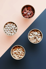 Pistachios, Peanuts, Pecans, Cashews in Boxes on a Combined Background
